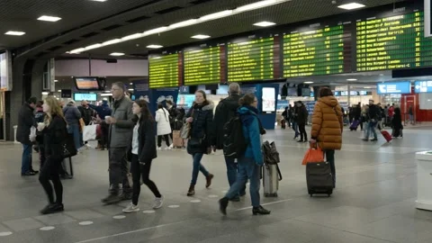 People watching the electronic timetable of the Belgian trains in the Stock Footage 237932468