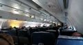 People watching a movie aboard an airplane Boeing 767 HD Footage
