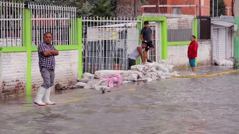 People watching the river created in the streets due the flood. Stock Footage 79848271
