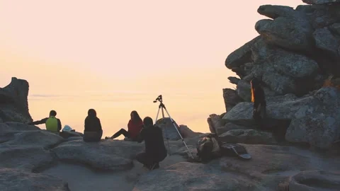 PEOPLE WATCHING THE SUNSET AND TAKING PHOTOS Stock Footage 94231025