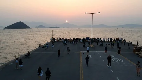People watching the sunset at Western district cargo bay, Hong Kong, China. Stock Footage 88023733