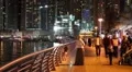People on the waterfront, night Dubai Marina, United Arab Emirates HD Footage