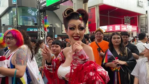 People wave rainbow flags during the LGBTQ+ Pride Parade, Bangkok, Thailand 4K Video stock 243560410