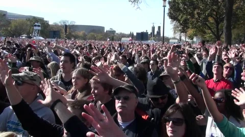 People wave their arms at a giant outdoor gathering. Stock Footage