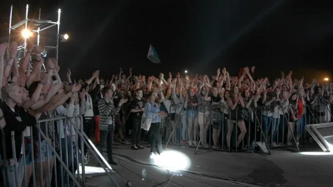 People Waving And Clapping Hands At Concert, Enjoying Music Stockbeeldmateriaal 89493543