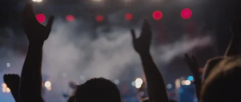 People waving hands and dancing in front of a stage of live show, slow motion Stock Footage 122011477
