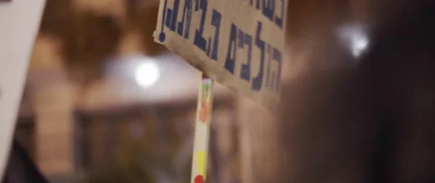 People waving posters in hebrew Stock Footage 152849347