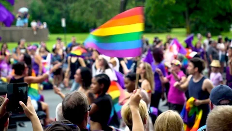 People waving rainbow flags during Montreal gay pride parade Stock Footage 114346677