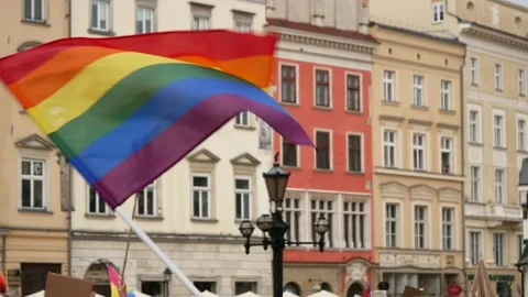 People waving rainbow flags during Kraków Equality March (Pride parade). Stock Footage 155347117
