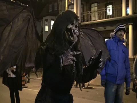 People wearing different costumes on Halloween night in Toronto Stock Footage