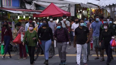 People wearing face mask in Little India streets , Singapore Stock Footage