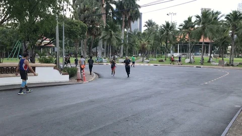 People Wearing Face Masks While Running and Walking Outdoors at Public Park Stock Footage 130096757