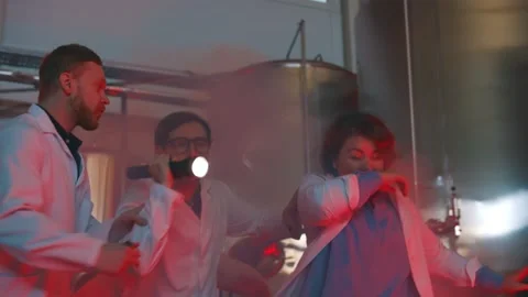 People wearing white coat running in factory building during fire Stock Footage 144530596