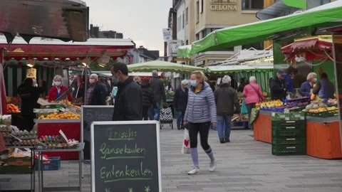 People on a weekly market wearing face masks Stock Footage