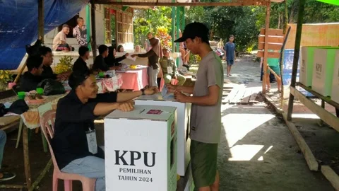 People who are currently voting in the (KPU) election for Governor and Regent Stock Footage 293702613