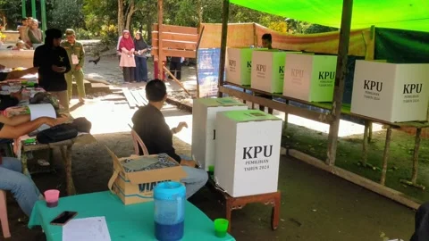 People who are currently voting in the (KPU) election for Governor and Regent Stock Footage 293702667