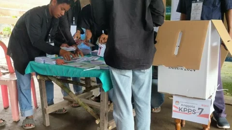 People who are currently voting in the (KPU) election for Governor and Regent Stock Footage 293703953