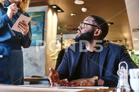 People who love to eat are always the best people. Young businessman came into Stock Photos