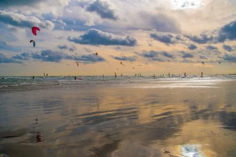 People windsurfing at the beach in the morning Stock Photos