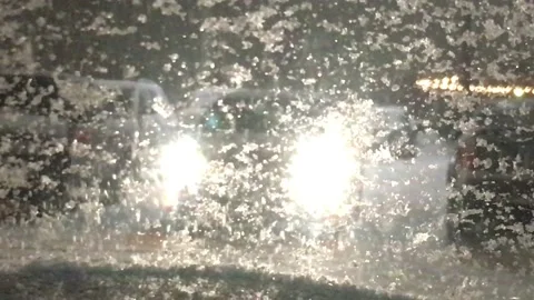 People in Winter Walking in Front of Headlights Stockbeeldmateriaal 101202204