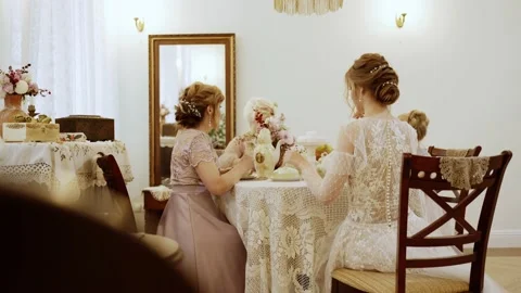 People. Women of different ages sit at an vintage table and drink tea Stock Footage 147131253