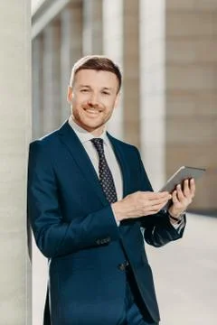 People, work and technology concept. Handsome male economist searches informa Foto stock