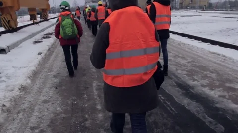 People in work helmet and reflective vest walks 库存影片 70939955