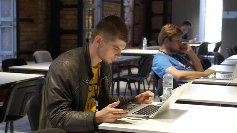 People work on laptops at coworking Stock Footage 86281314