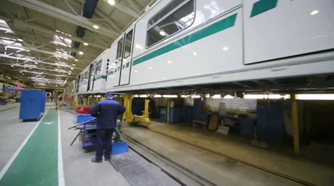 People work with materials near train at factory Stock Footage