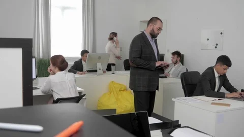 People work at office, on of them talk on phone. Stock Footage 116620623