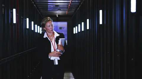 People working in computer server room data center. Walking along rows of super Vídeo Stock 32722678