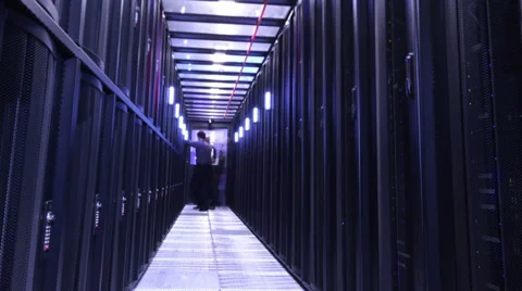 People working in computer server room data center. Walking along rows of super Stock Footage 32723593
