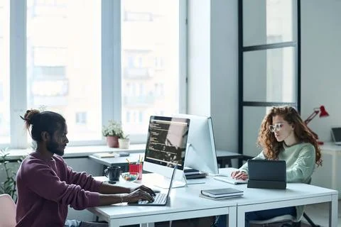 People working on computers in IT office Stock Photos