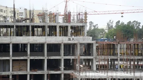 People working at a construction site of a building in India, developing country Stock Footage 93258805