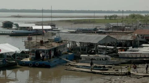 People working on a dock with some boats in Iquitos, Peru Stock Footage 188911432