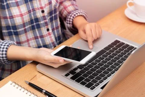 People working from home using smart phone and notebook laptop computer Stock Photos