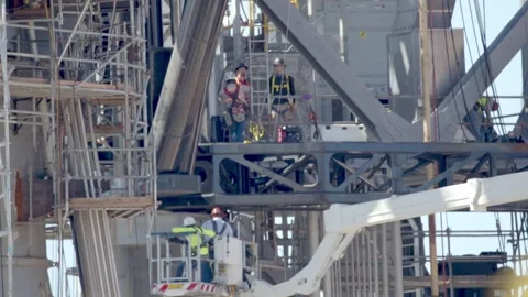 People Working at SpaceX Orbital launch integration tower at Starbase, Texas Stock Footage 163561947