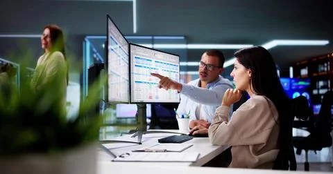 People Working With Spreadsheet Data On Computer Monitor Stock Photos