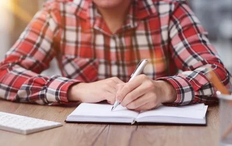 People write on a notepad and work in the office on a wooden table Stock Photos