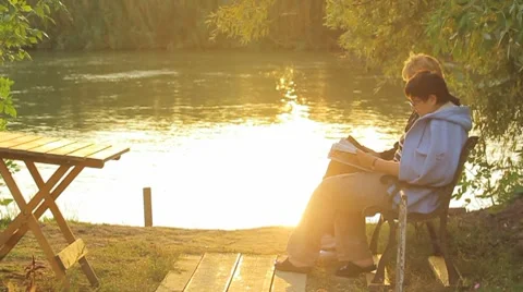 Peoples rest at the river in sunset Stock Footage 8761439