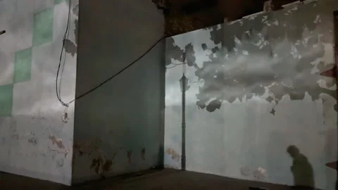 People's shadows are projected onto a wall with a cloudy Stock Footage 312897673