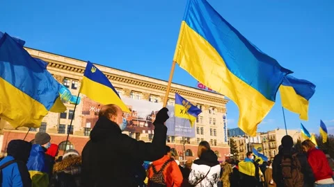 Peoples in the square with Ukrainian flags protest against the war and Video stock 214328092