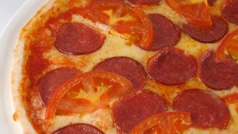Peperoni pizza, includes sliced salami, tomatoes and mozzarella cheese Stock Footage 87690606