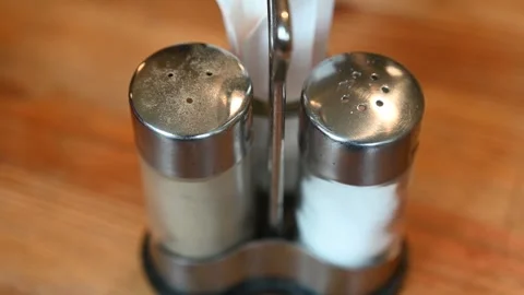 Pepper and salt shakers on the table in restaurant. Stock Footage 305506258