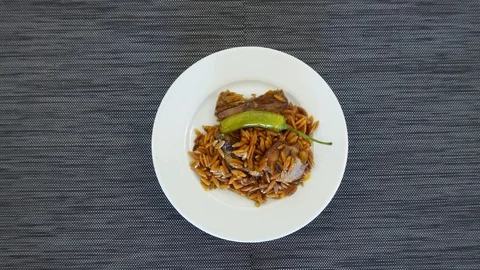 Pepper and side dish on a white rotating plate. Stock-Footage 120106961