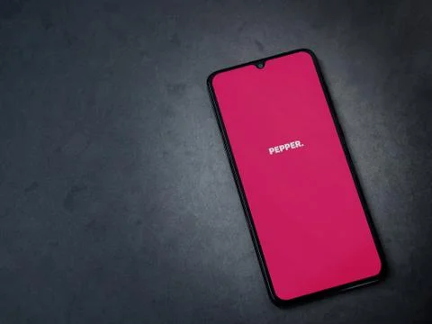Pepper app launch screen with logo on the display of a black mobile smartphon Stock Photos