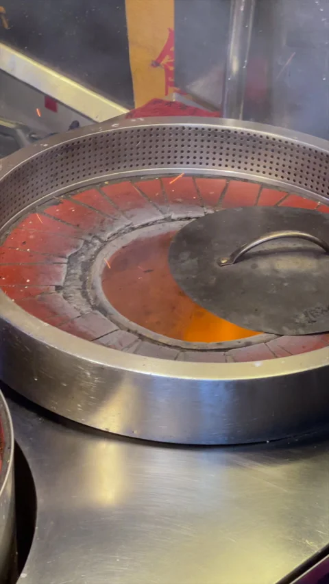 Pepper Buns Baking Against The Glowing Wall Of A Charcoal Drum Oven Video stock 342829827