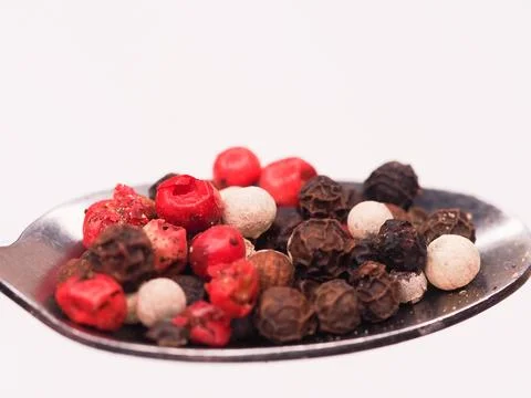 Pepper corn on a spoon Stock Photos