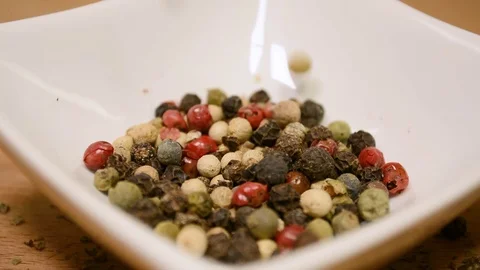 Pepper falling into white porcelain container Stock-Footage 101356408