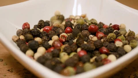Pepper falling into white porcelain container Stock-Footage 101356411